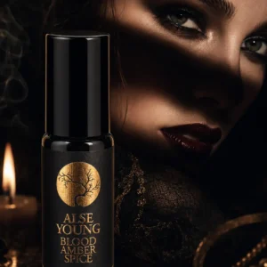 Dark, mysterious beauty and perfume oil bottle.